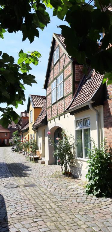 a cobblestone street in front of a house at Torhaus in Lüneburg