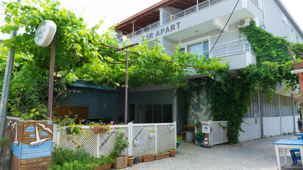 a building with a lot of plants in front of it at Mer Apart Pansiyon in Avşa Adası