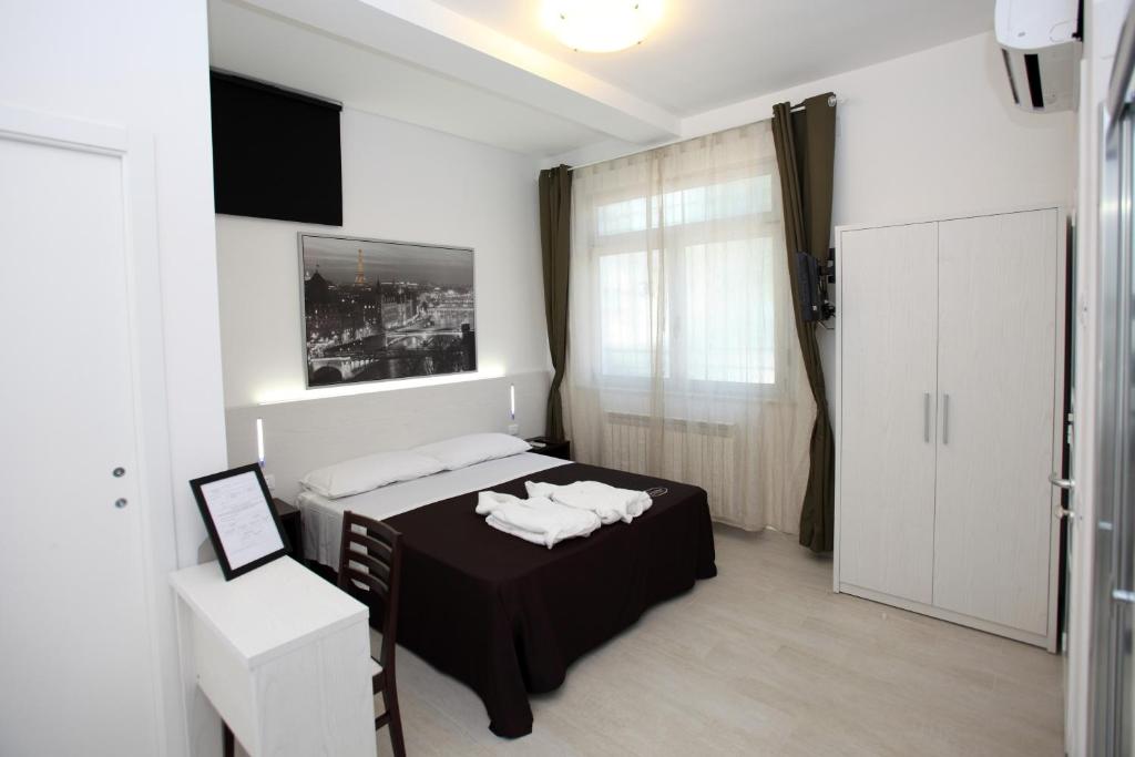 a bedroom with a bed with towels on it at Orchidea Rooms & Suites in Civitanova Marche