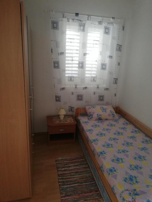 Postel nebo postele na pokoji v ubytování Apartmani Iva