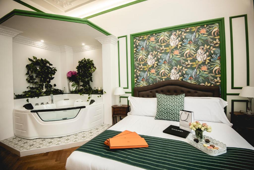 a bedroom with a tub and a bed and a sink at PRATI 1930 Boutique apartments Rome in Rome
