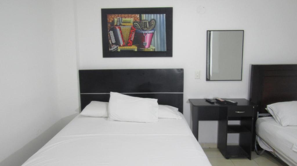 Postel nebo postele na pokoji v ubytování Hotel Nuevo Tio