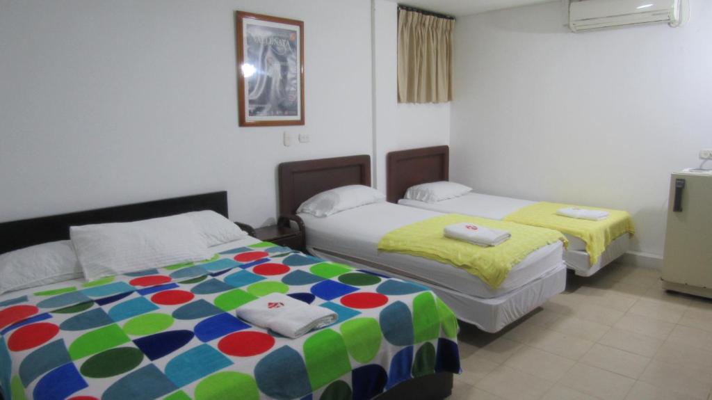 Postel nebo postele na pokoji v ubytování Hotel Nuevo Tio