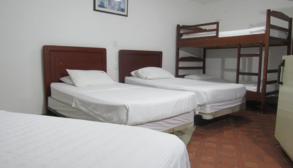 Postel nebo postele na pokoji v ubytování Hotel Nuevo Tio