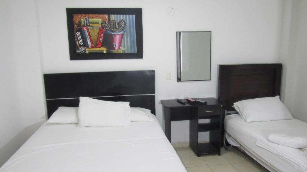 Postel nebo postele na pokoji v ubytování Hotel Nuevo Tio