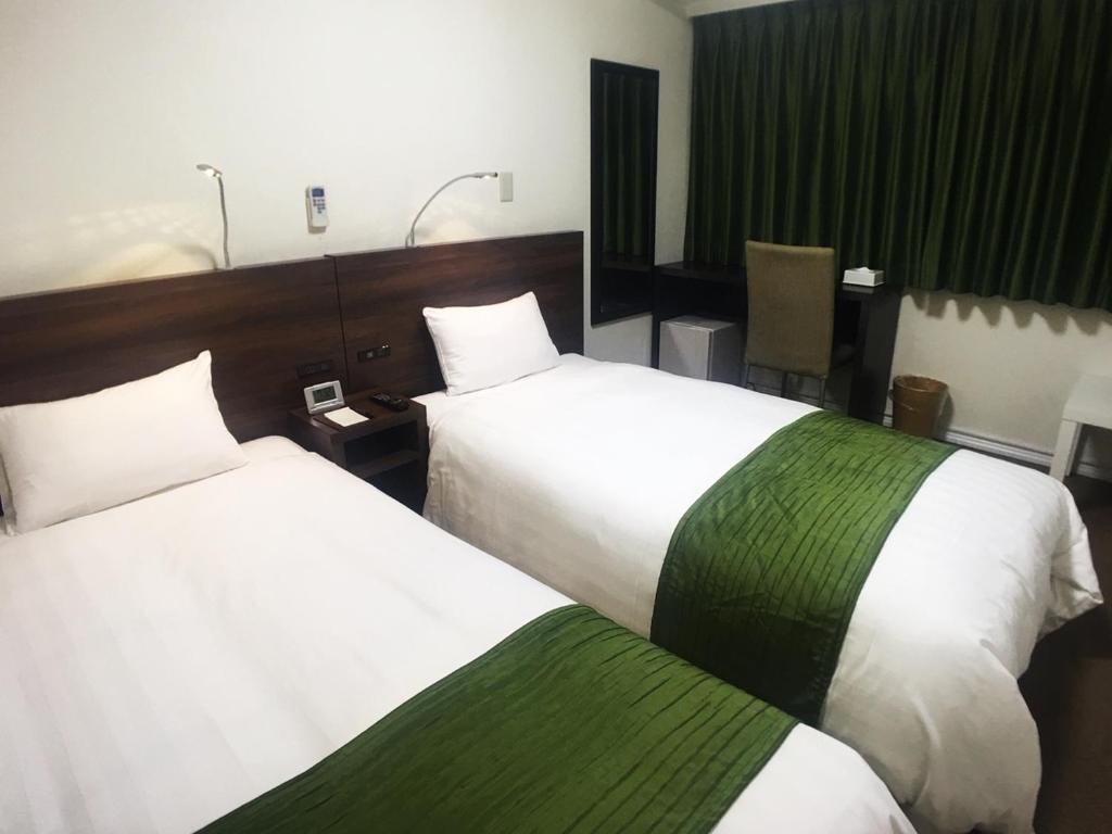 Postel nebo postele na pokoji v ubytování High Set HOTEL SHIZUOKA Inter