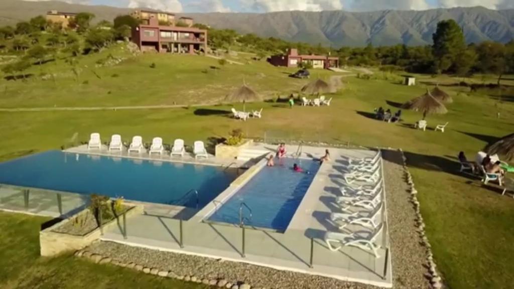 een uitzicht over een zwembad in een veld bij LA TOSCANA casas y suites in Nono