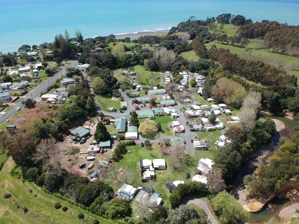 an aerial view of a campground with a bunch of tents at Orere Point Top 10 Holiday Park in Auckland