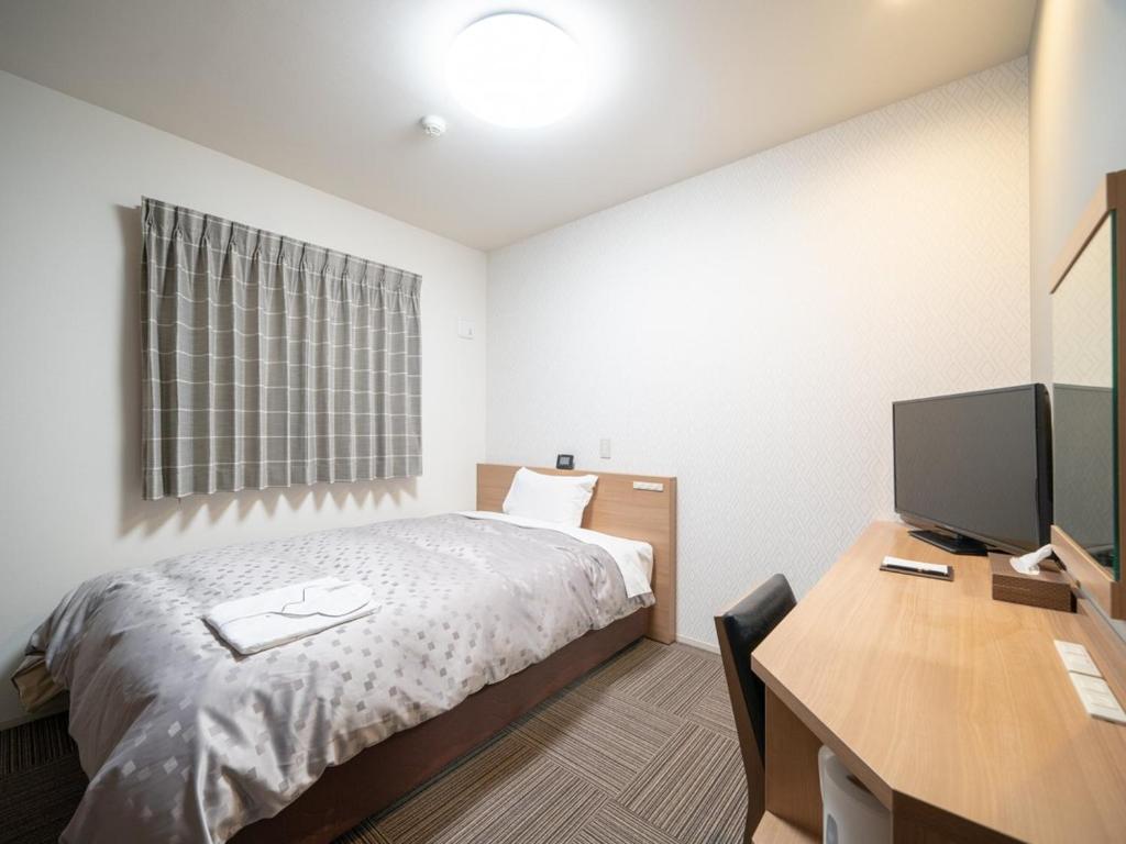 Postel nebo postele na pokoji v ubytování Amagasaki Plaza Hotel Hanshin Amagasaki