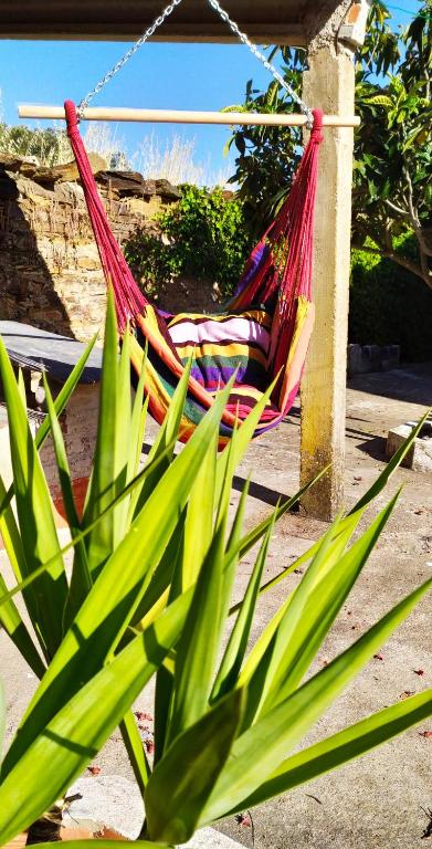 a person laying in a hammock on a porch at Casa Menir in Monsaraz