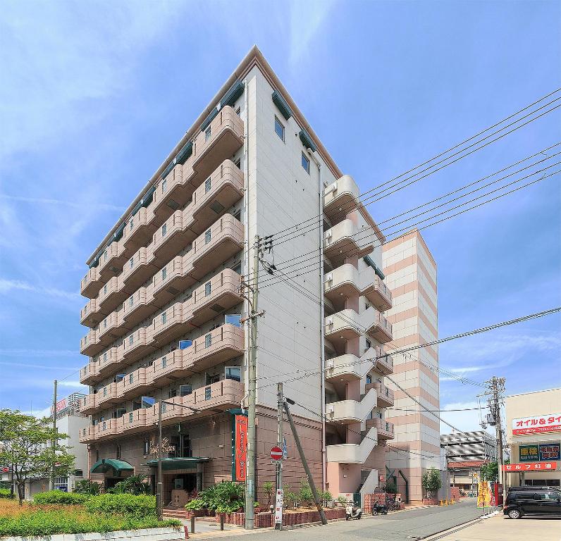 a tall building with balconies on the side of a street at Lucky Sun in Nishinomiya