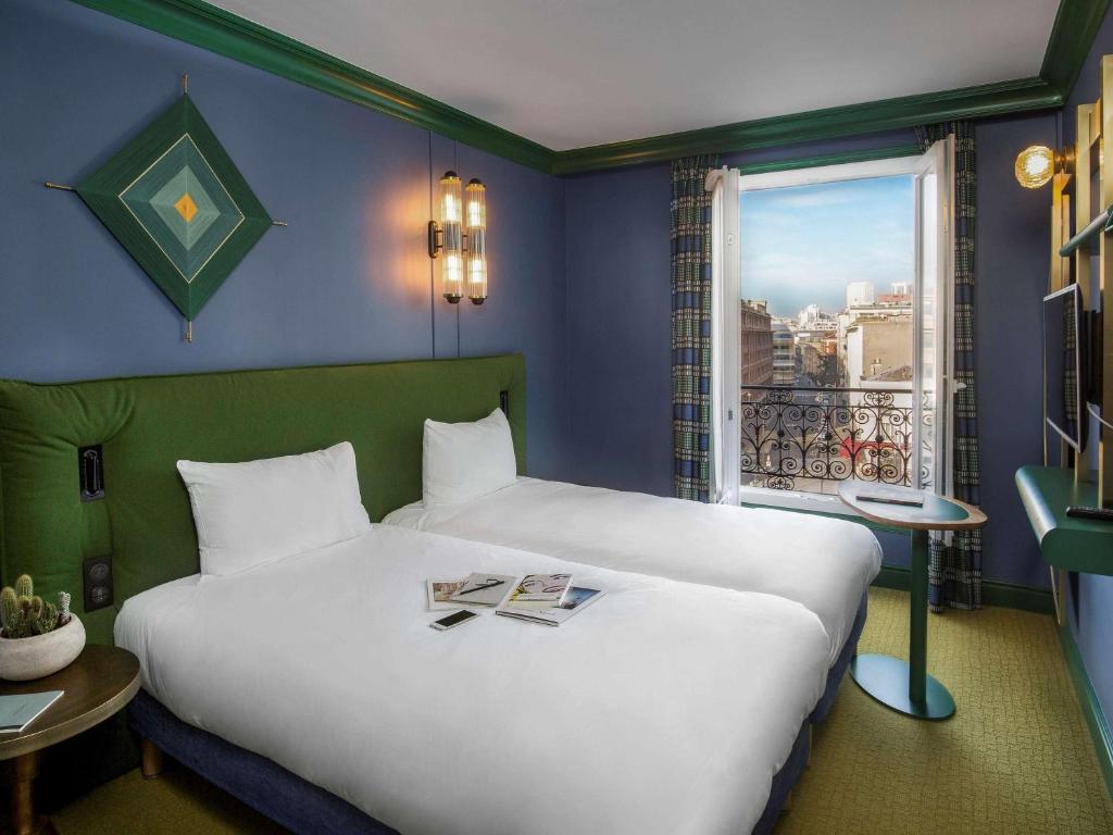 a bedroom with a large white bed and a window at ibis Styles Paris Nation Cours de Vincennes in Paris