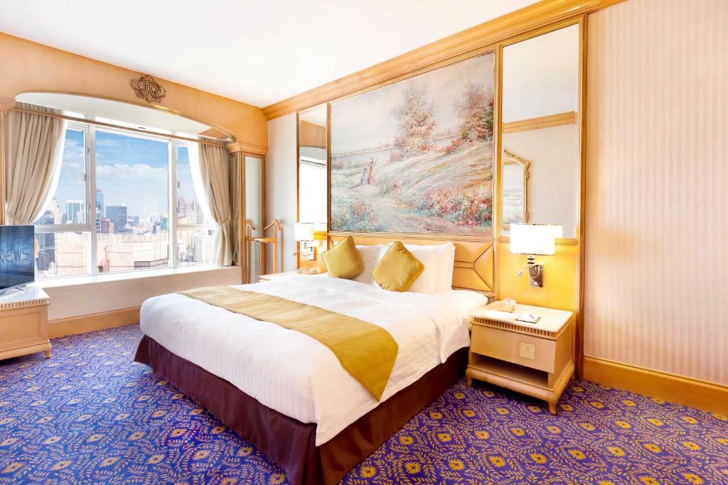 Voodi või voodid majutusasutuse Regal Hongkong Hotel toas