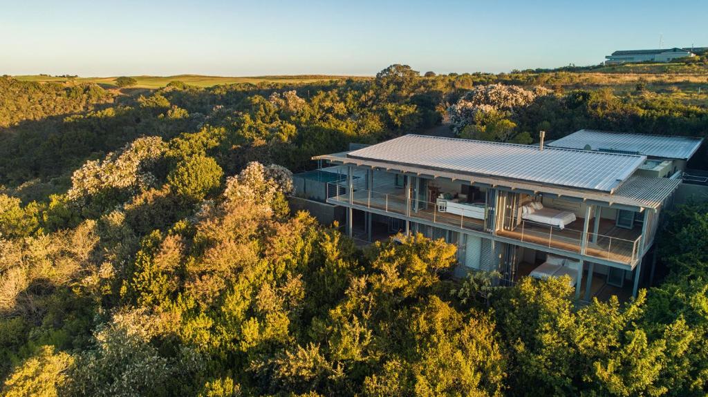 an aerial view of a house in the woods at Oubaai Villa by Raw Africa Collection in Herolds Bay