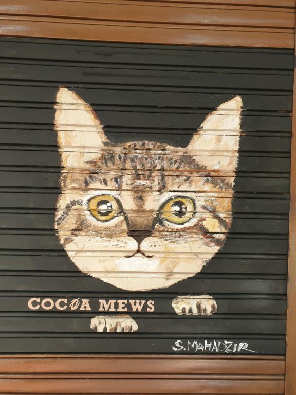 a painting of a cat on a garage door at Cocoa Mews Cafe and Homestay in George Town