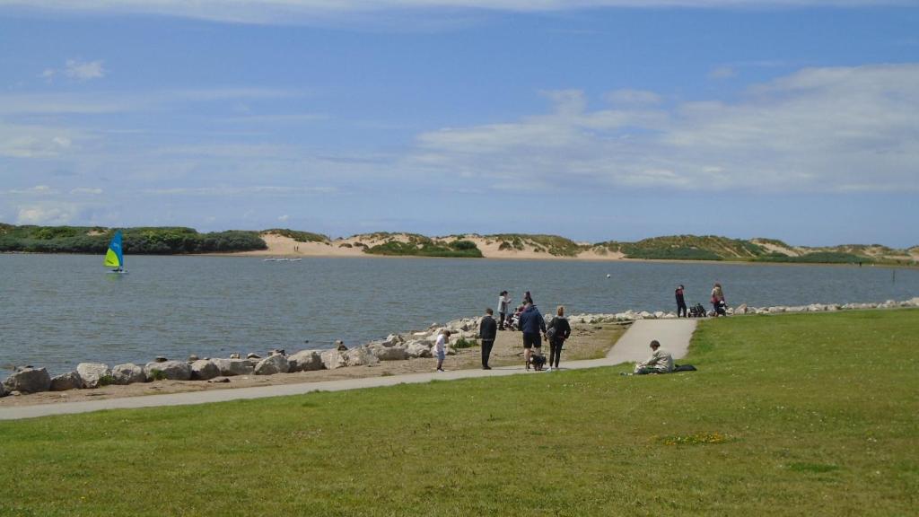 a group of people walking on a sidewalk near a body of water at TEA in Liverpool - Private - Quiet - Ground Floor - En-suite - Walk-in-shower in Liverpool