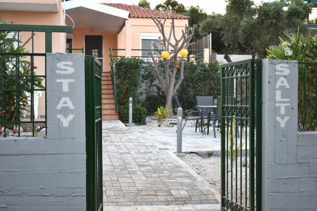 a gate to a house with a sign that says santa ana at Stay Salty - Two Different Houses in Marathi