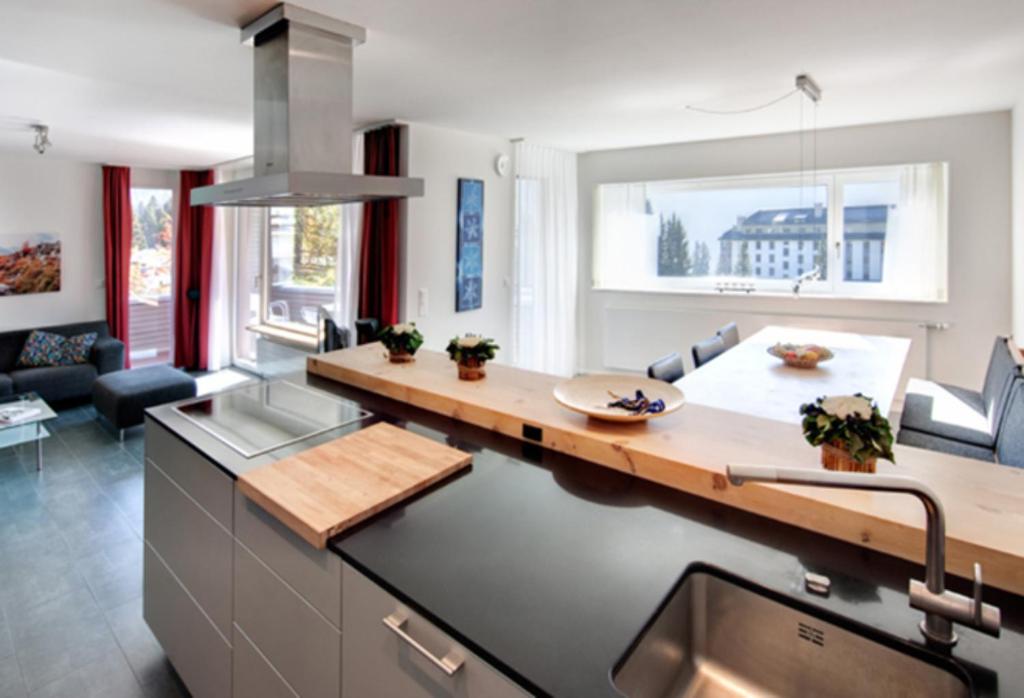 a kitchen with a sink and a counter top at Chesa Kristella in Arosa