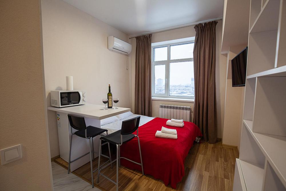 a small room with a bed and a desk with a microwave at New quiet place in Kiev in Kyiv