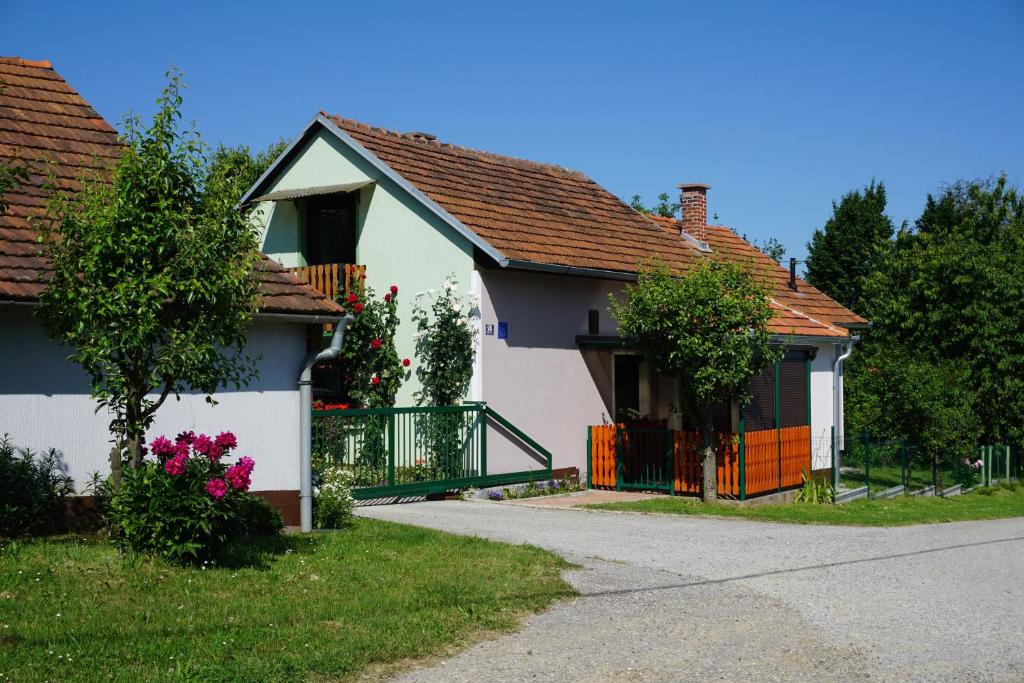 a white house with a gate and a driveway at Holiday Home Mađerka in Štrigova