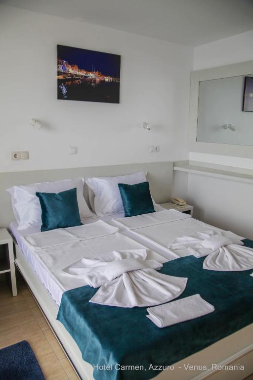 Postel nebo postele na pokoji v ubytování Hotel Carmen Azzuro