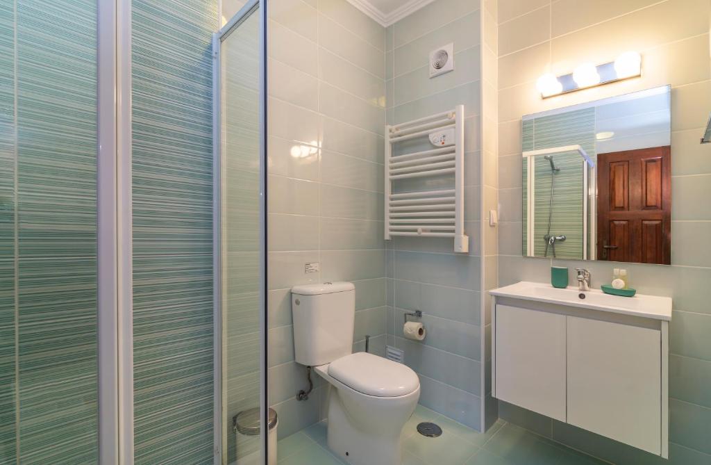 a bathroom with a toilet and a sink and a shower at The Old Village, Prestige and Solar by Village 4U in Vilamoura