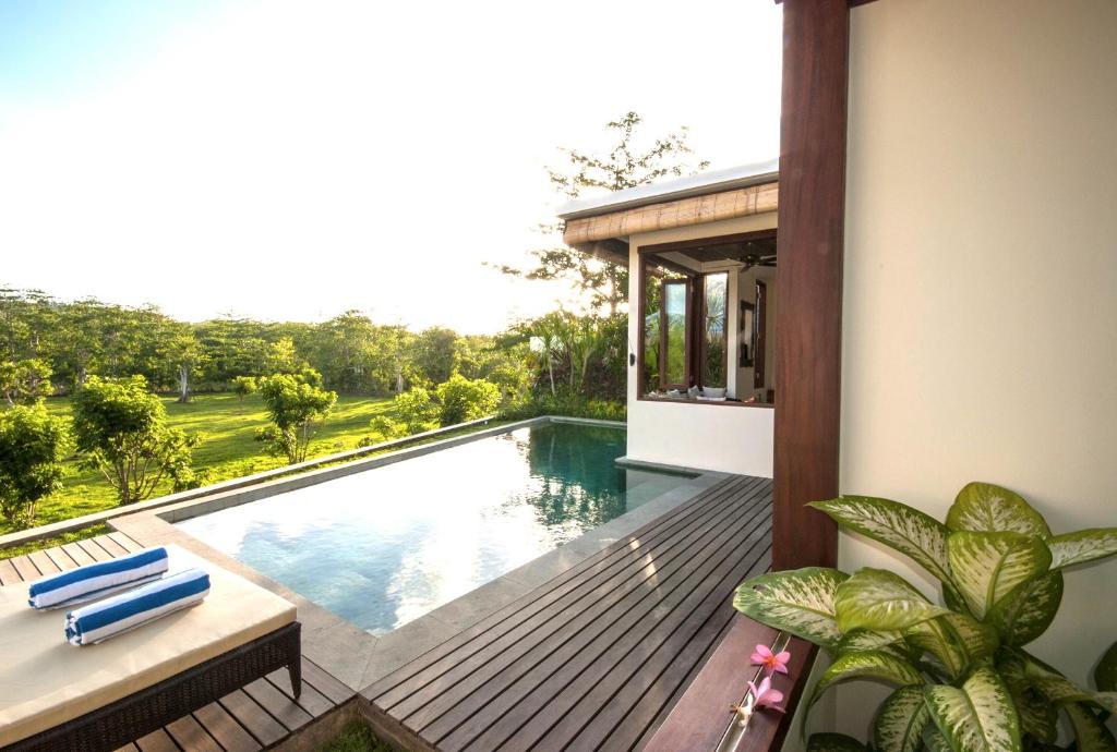 
a patio with a view of the water at Canang Villas Bingin in Uluwatu
