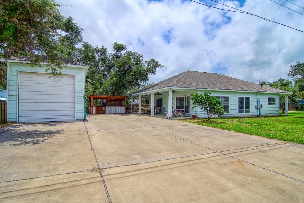 a white house with a garage and a driveway at Myrtle in Rockport