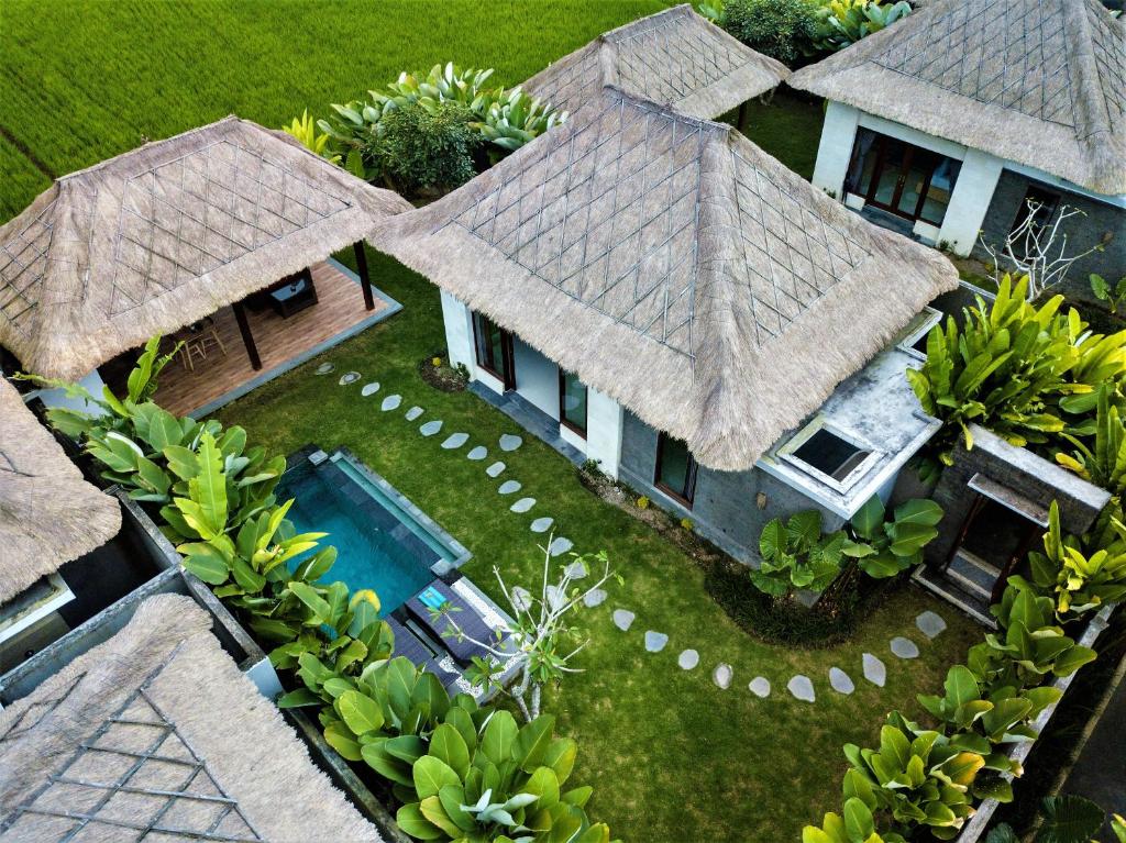an aerial view of a house with a swimming pool at Three Gold Luxury Private Villas in Ubud