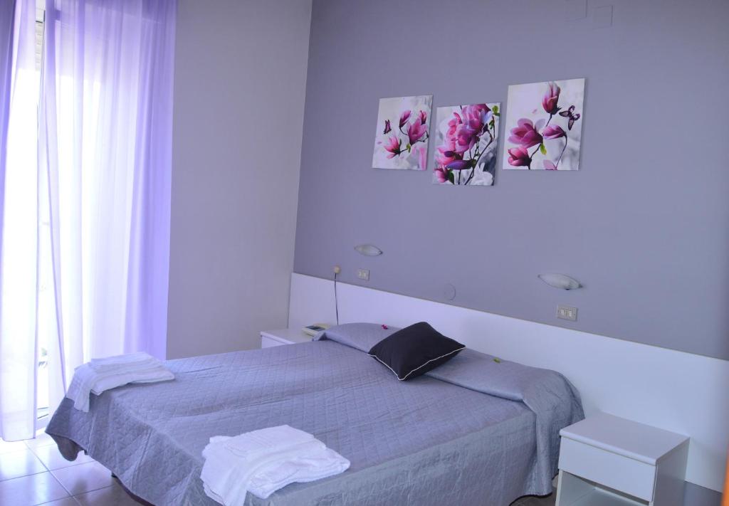 Postel nebo postele na pokoji v ubytování Hotel Perla