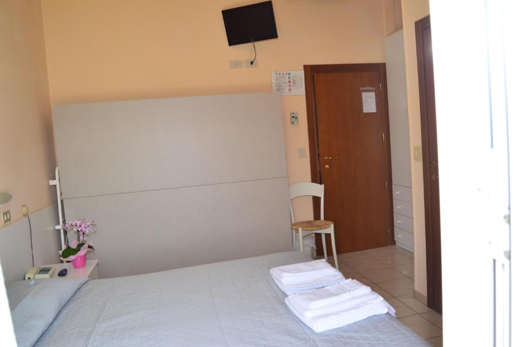 Postel nebo postele na pokoji v ubytování Hotel Perla