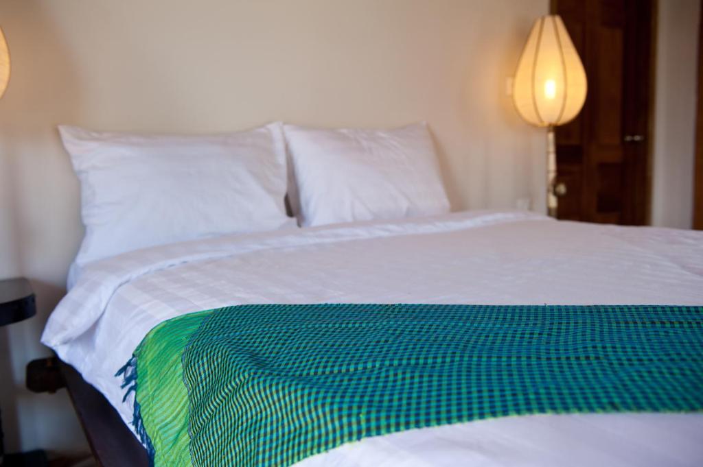 Postel nebo postele na pokoji v ubytování Bambu Hotel