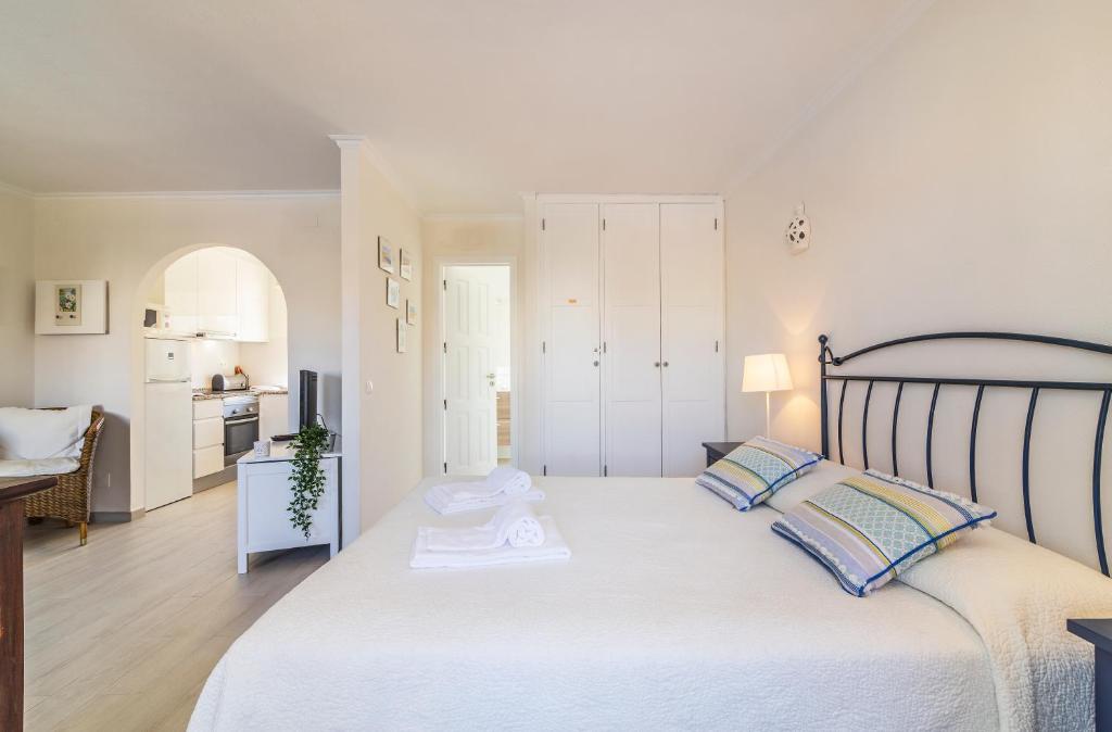 a bedroom with a large white bed with two pillows at The Old Village, Prestige and Solar by Village 4U in Vilamoura