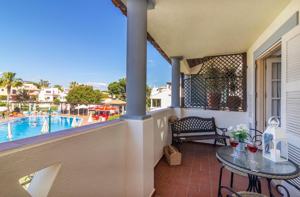 a balcony with a table and a swimming pool at The Old Village, Prestige and Solar by Village 4U in Vilamoura