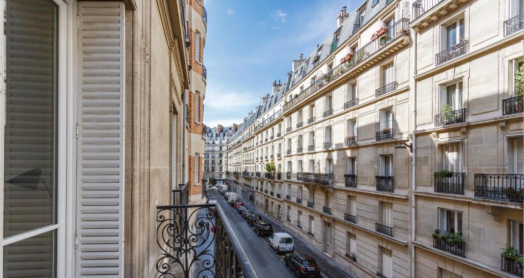 a view of a city street from a window at Courcelles Parc Monceau in Paris