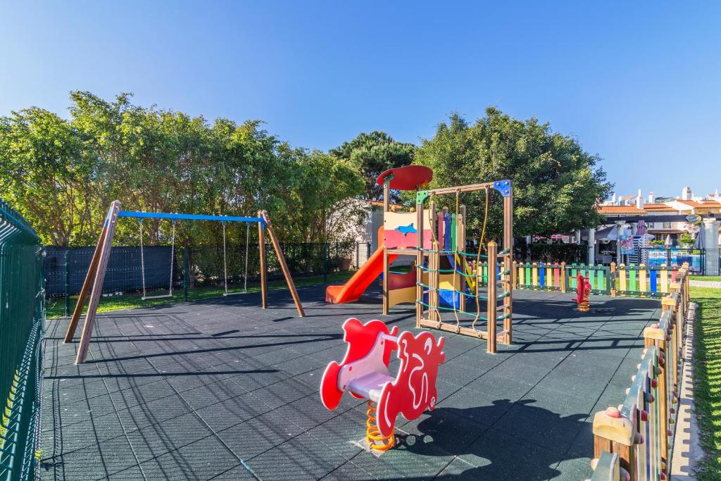 a park with a playground with a slide and swings at The Old Village, Prestige and Solar by Village 4U in Vilamoura