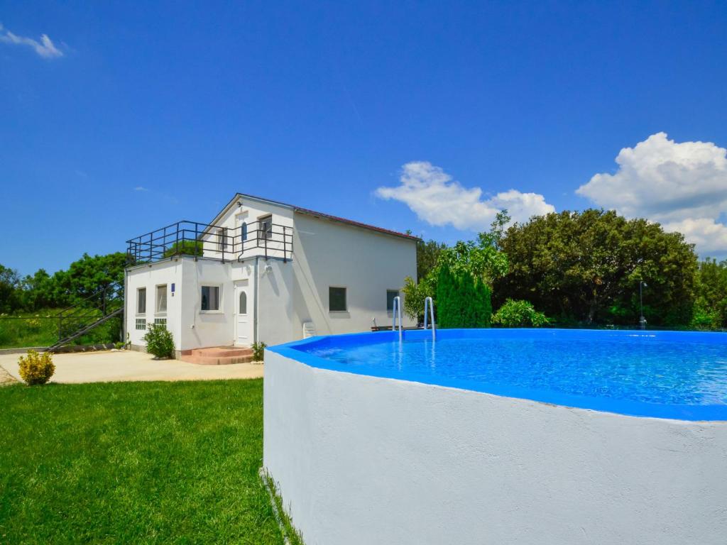 a house with a swimming pool in the yard at Holiday Home Martina by Interhome in Valdebek