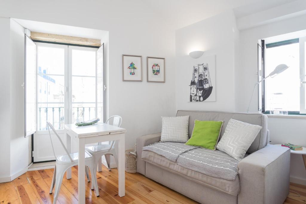 a living room filled with furniture and a window at Apartments Center Alfama in Lisbon
