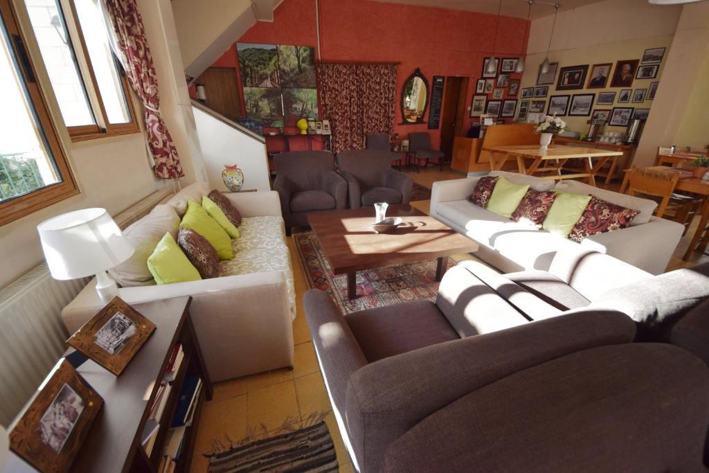a living room with couches and a table at Christys Palace Hotel in Pedoulas