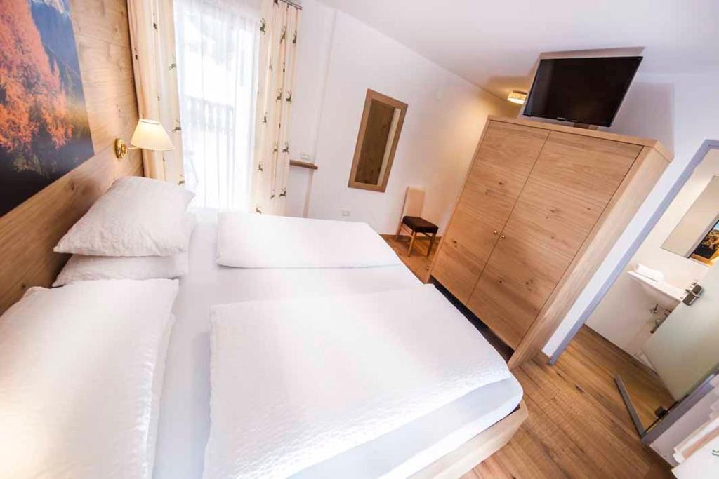 Postel nebo postele na pokoji v ubytování Hotel Garni Morene