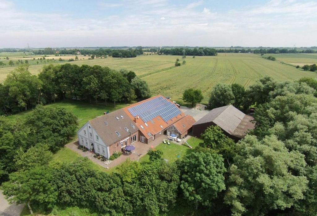 an aerial view of a large house with a solar roof at Ferienhof Gerdes an der Nordsee in Wangerland