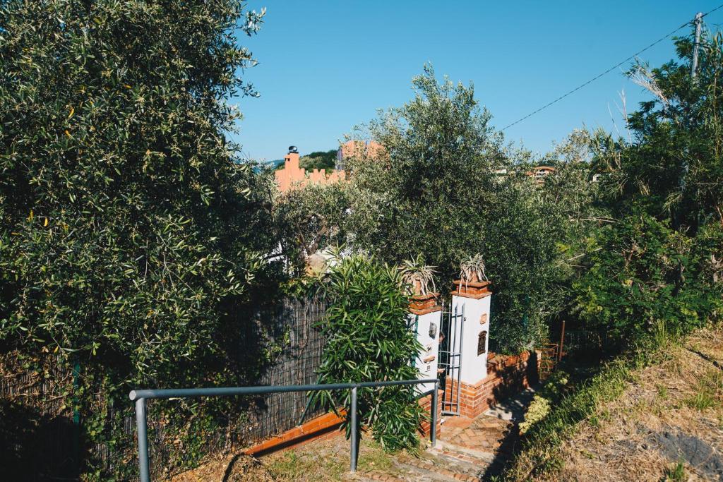 a house with a fence and some trees at La Torretta in Lerici