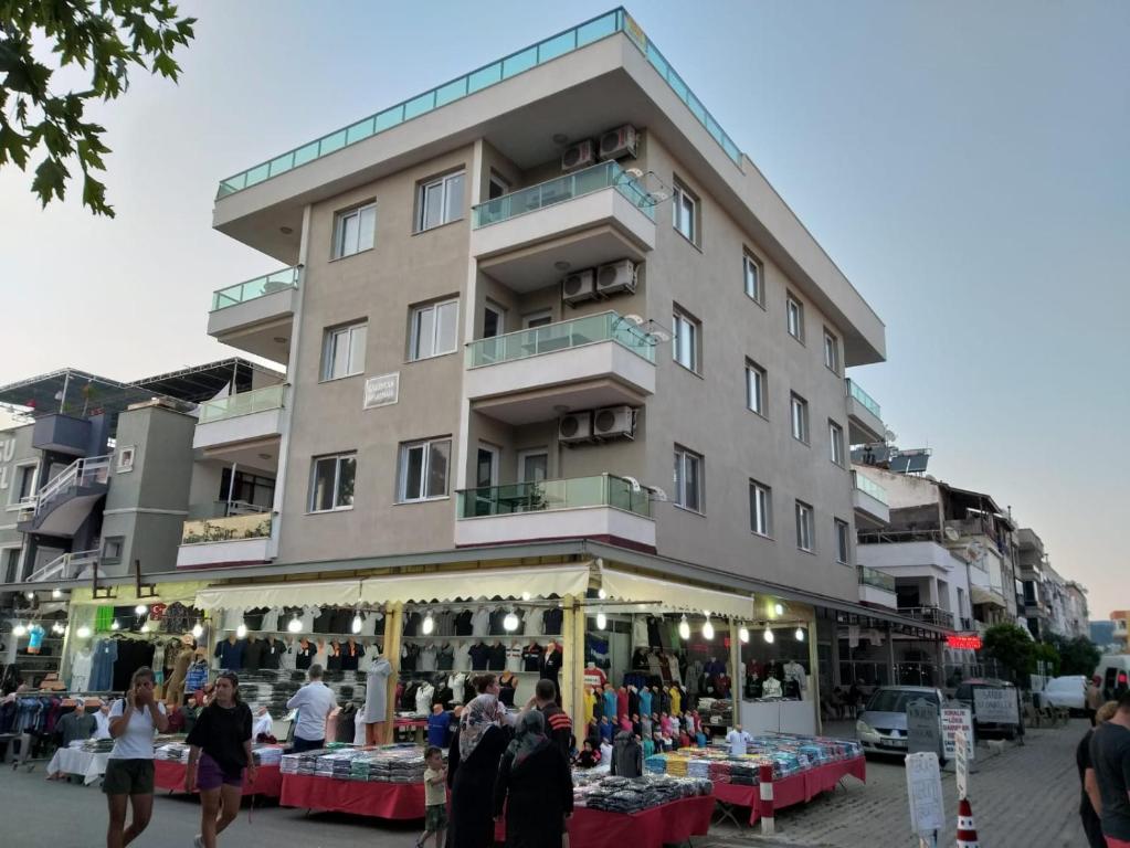 a building with a flea market in front of it at GÜMÜLDÜR ÇALIŞKAN APART 1 in Gumuldur