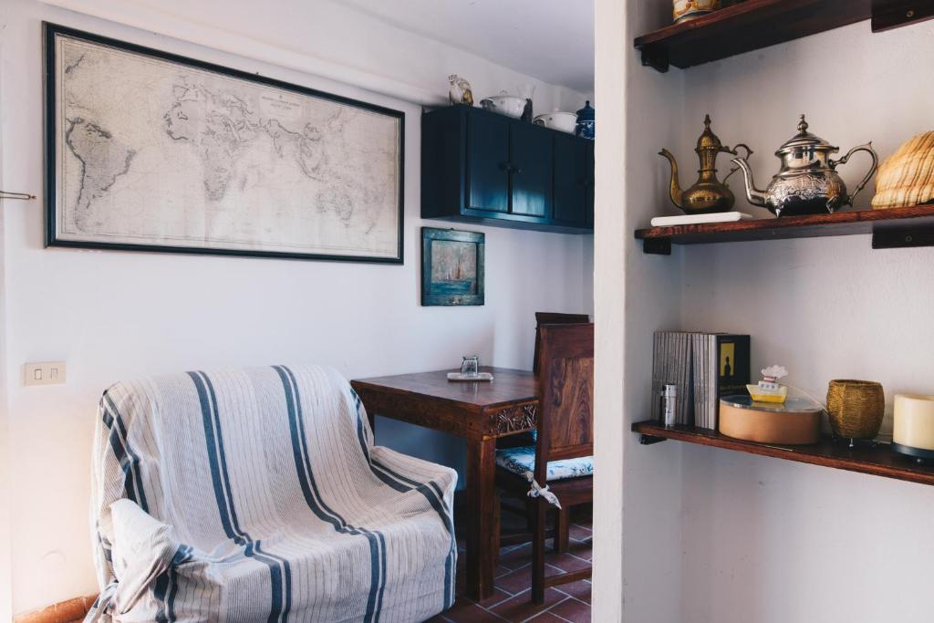 a room with a chair and a table with a map on the wall at La Torretta in Lerici