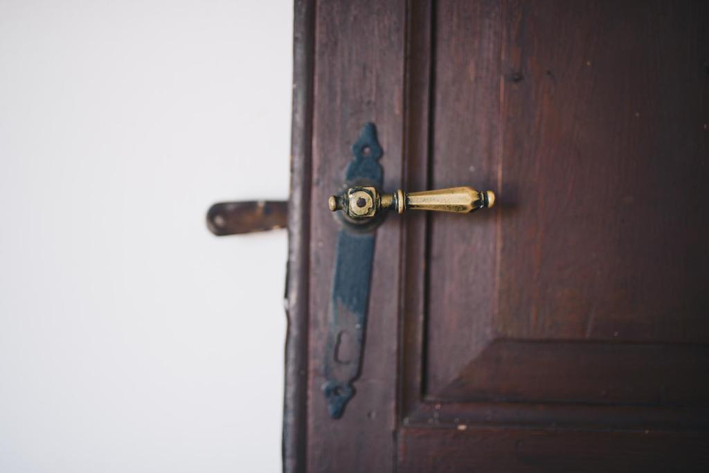 a wooden door with ajar doorhandle with a wooden door at La Torretta in Lerici