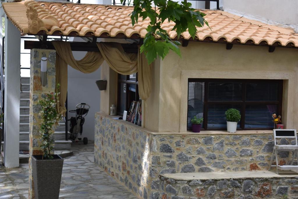 a house with a window and a stone wall at Hotel Zachos in Troulos