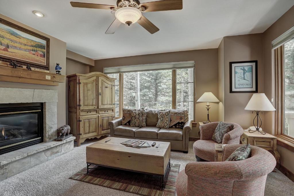 a living room with a couch and a fireplace at 2Br- Arrowhead Village- Great Location And Gorgeous Condo Condo in Beaver Creek