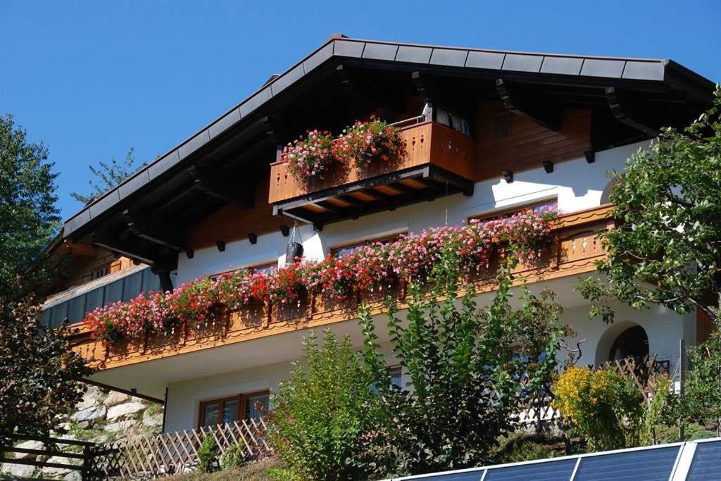 a building with flower boxes on a balcony at Haus Marent in Bartholomäberg