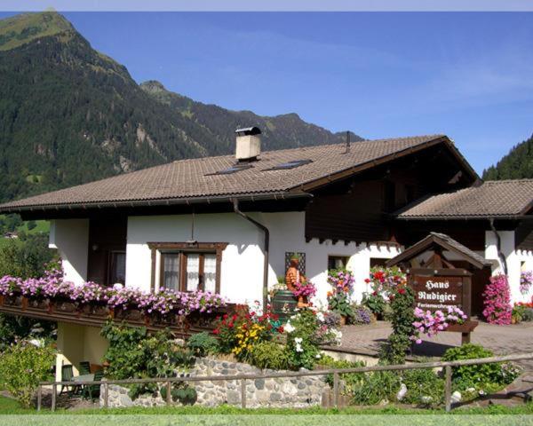a small house with flowers in front of it at Rudigier Margret und Franz in Sankt Gallenkirch