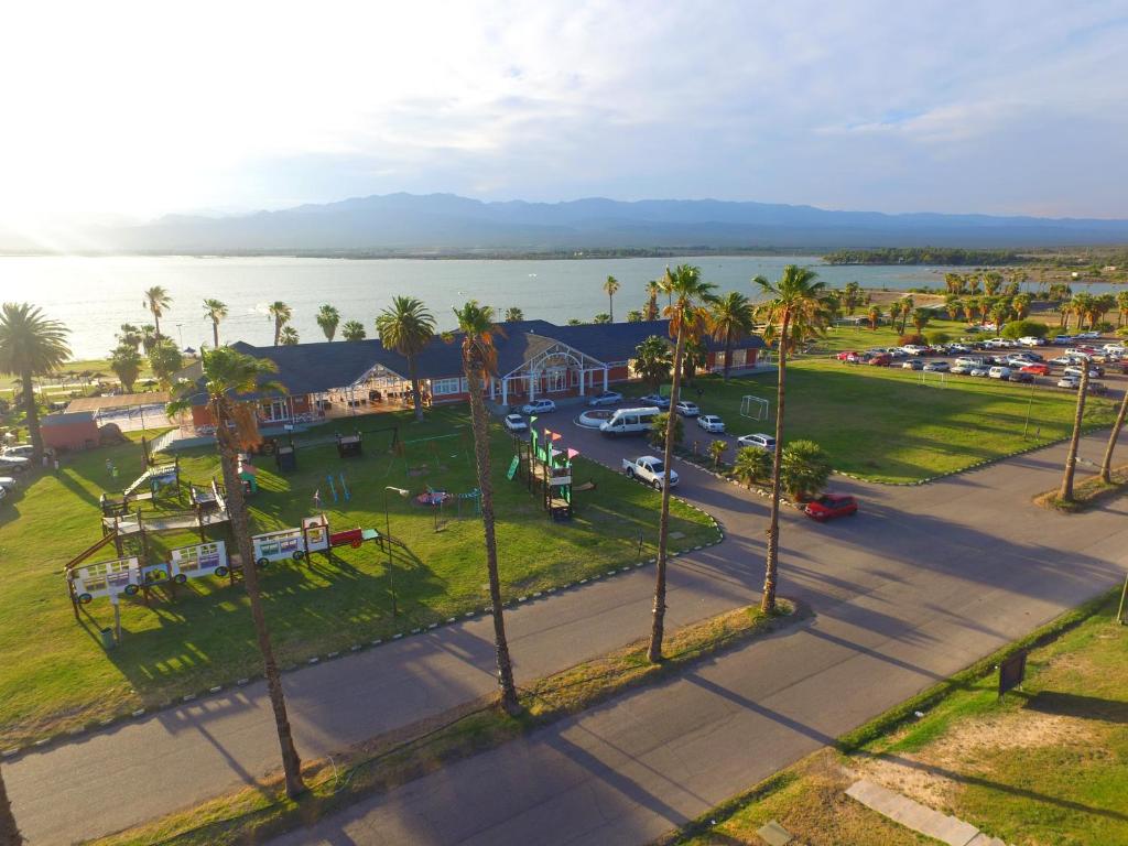 an aerial view of a town with palm trees and the water at Del Bono Beach Complejo Bahia in Las Tapias
